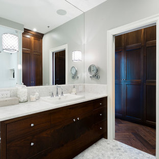 Aménagement d'une salle de bain principale classique de taille moyenne avec un lavabo posé, un placard à porte plane, des portes de placard en bois sombre, un plan de toilette en onyx, une douche d'angle, un WC à poser, un carrelage blanc, un carrelage de pierre, un mur gris et un sol en marbre.