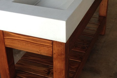 Minimalist bathroom photo in Hawaii with an integrated sink, open cabinets, brown cabinets and concrete countertops