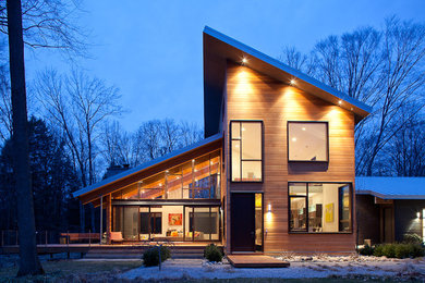 Inspiration for a contemporary exterior in Grand Rapids with wood siding and a shed roof.