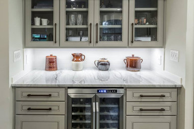 Dry bar - contemporary single-wall dry bar idea in New Orleans with raised-panel cabinets