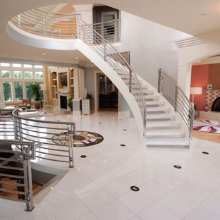 Photo of an expansive classic acrylic curved staircase in DC Metro with open risers.