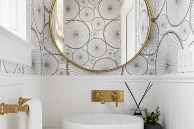 Example of a small transitional wall paneling and wallpaper powder room design in San Francisco with multicolored walls, a vessel sink, white countertops and a built-in vanity