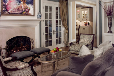 Example of a mid-sized transitional formal and enclosed dark wood floor living room design in Detroit with blue walls, a standard fireplace, a stone fireplace and no tv
