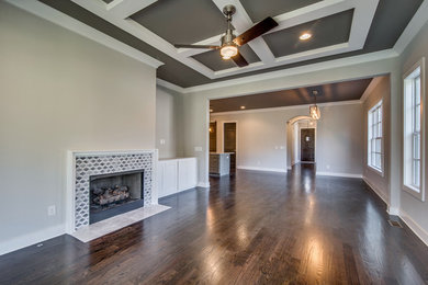 Living room - formal dark wood floor living room idea in Nashville with gray walls, a standard fireplace and a stone fireplace