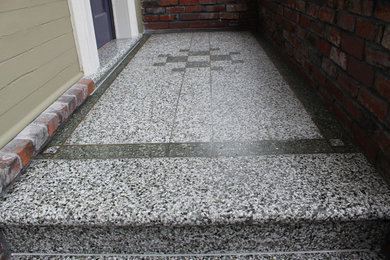 Example of a mid-sized ornate terrazzo floor front door design