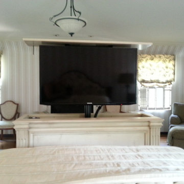 TV lift cabinets at foot of bed