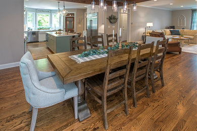 Example of a cottage medium tone wood floor and brown floor kitchen/dining room combo design in Philadelphia with gray walls