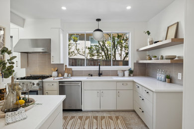 Inspiration for a mid-sized contemporary l-shaped porcelain tile and beige floor enclosed kitchen remodel in San Francisco with an undermount sink, flat-panel cabinets, beige cabinets, quartz countertops, beige backsplash, porcelain backsplash, stainless steel appliances, no island and white countertops