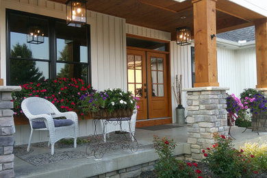 Inspiration for a large craftsman porch remodel in Other with a roof extension