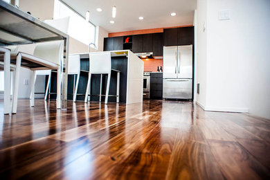Photo of a mid-sized contemporary kitchen/dining combo in Seattle with white walls and dark hardwood floors.