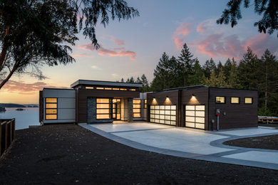 Inspiration for a large contemporary multicolored two-story mixed siding exterior home remodel in Vancouver with a black roof