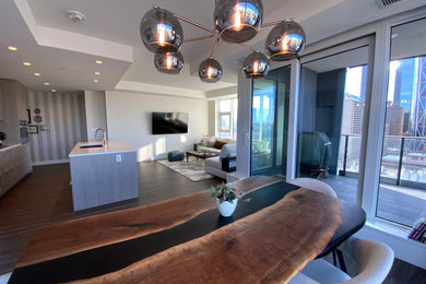 Example of a mid-sized eclectic medium tone wood floor, brown floor and wallpaper kitchen/dining room combo design in Calgary with beige walls