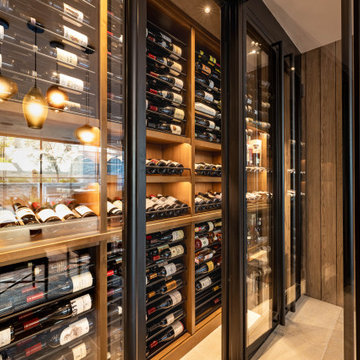 Modern Bronze Steel Wine Wall and Liquor Display in Luxury Custom Home Basement