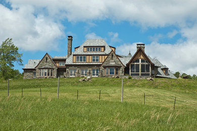Inspiration for a large timeless gray three-story mixed siding exterior home remodel in Other