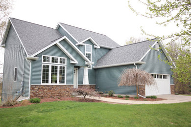 Mid-sized traditional blue two-story vinyl gable roof idea in Other