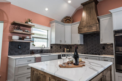 Example of a mid-sized transitional eat-in kitchen design in Dallas with an undermount sink, shaker cabinets, gray cabinets, quartz countertops, black backsplash, ceramic backsplash, stainless steel appliances, an island and white countertops