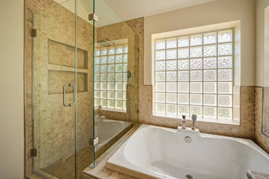 Inspiration for a large modern master brown tile and marble tile cement tile floor, brown floor and double-sink bathroom remodel in Houston with flat-panel cabinets, white cabinets, a two-piece toilet, white walls, an undermount sink, granite countertops, a hinged shower door, beige countertops, a niche and a built-in vanity