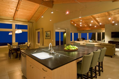 Inspiration for a mid-sized craftsman l-shaped ceramic tile and beige floor open concept kitchen remodel in San Francisco with an undermount sink, flat-panel cabinets, light wood cabinets, soapstone countertops, stainless steel appliances and an island