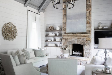 Design ideas for a country family room in Atlanta with grey walls, a standard fireplace, a stone fireplace surround and a wall-mounted tv.