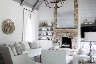 Example of a cottage family room design in Atlanta with gray walls, a standard fireplace, a stone fireplace and a wall-mounted tv