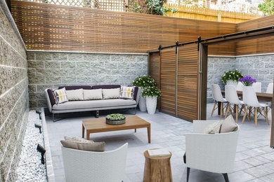 Photo of a scandinavian courtyard patio in New York with a container garden and no cover.