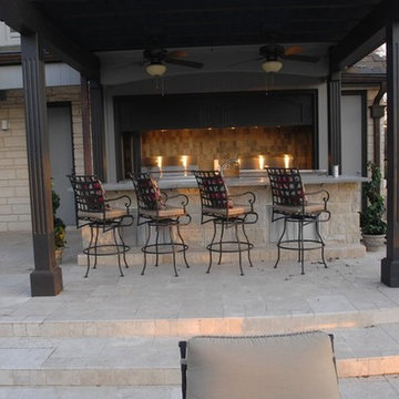 Outdoor Kitchen with Clean Concrete Countertops with Charcoal and Gas Grills