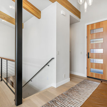 Interior Entryway showcases custom wood stained door with accompanying windows