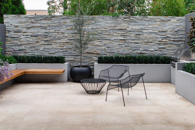 Inspiration for a contemporary backyard patio in Other with tile and no cover.