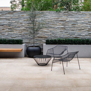 Inspiration for a contemporary backyard patio in Other with tile and no cover.
