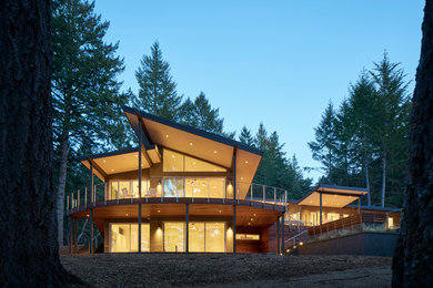 Mid-sized trendy gray two-story stucco exterior home photo in San Francisco with a shed roof
