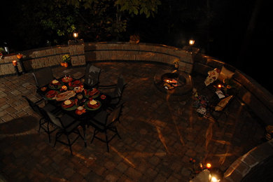 Example of a classic backyard concrete paver patio design in Other