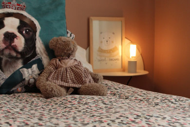 Inspiration for a mid-sized transitional gender-neutral medium tone wood floor kids' room remodel in Other with pink walls