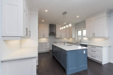 Large trendy u-shaped enclosed kitchen photo in Toronto with an undermount sink, shaker cabinets, white cabinets, quartz countertops, white backsplash, an island and white countertops
