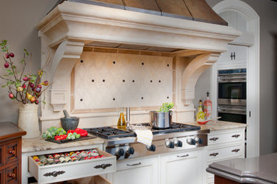 Photo of a large traditional u-shaped eat-in kitchen in Other with a farmhouse sink, recessed-panel cabinets, white cabinets, stainless steel appliances, dark hardwood floors, with island and stone tile splashback.