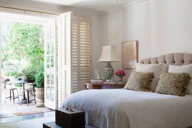 Design ideas for a large traditional master bedroom in Los Angeles with white walls and dark hardwood floors.
