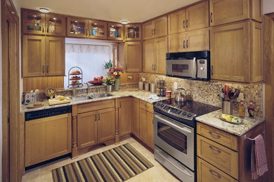 Example of a small classic l-shaped kitchen design in New York with a double-bowl sink, recessed-panel cabinets, light wood cabinets, wood countertops, stainless steel appliances and no island