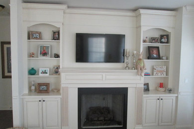 Example of a mid-sized classic open concept carpeted and beige floor living room design in Philadelphia with white walls, a standard fireplace, a plaster fireplace and a wall-mounted tv