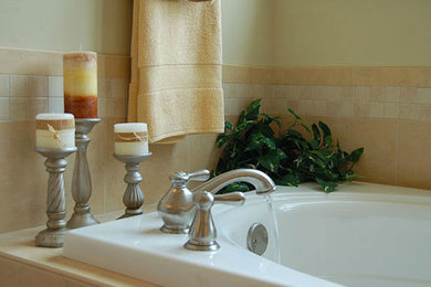 Example of a beige tile drop-in bathtub design in Richmond