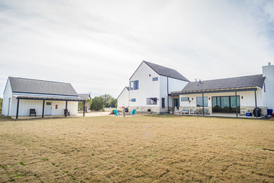Inspiration for a mid-sized farmhouse white two-story mixed siding exterior home remodel in Austin with a mixed material roof