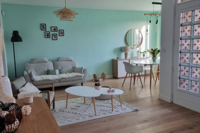Aménagement d'un salon scandinave de taille moyenne et ouvert avec un mur bleu, parquet clair et un téléviseur indépendant.