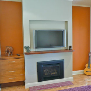 Home theater - mid-sized cottage enclosed light wood floor and beige floor home theater idea in Newcastle - Maitland with orange walls