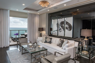 Example of a large trendy formal and open concept dark wood floor and brown floor living room design in Miami with gray walls, a ribbon fireplace, a stone fireplace and no tv