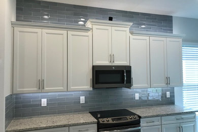 Glass tile backsplash and above cabinets w/lighting install