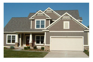 Large elegant beige two-story mixed siding exterior home photo in Grand Rapids