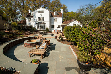 Large elegant backyard brick patio photo in Charlotte with a fire pit and no cover