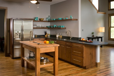 Inspiration for a mid-sized transitional l-shaped medium tone wood floor and brown floor kitchen remodel in Other with an undermount sink, flat-panel cabinets, medium tone wood cabinets, stainless steel appliances and an island