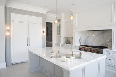 Transitional u-shaped eat-in kitchen in Toronto with an undermount sink, shaker cabinets, white cabinets, marble benchtops, white splashback, marble splashback, stainless steel appliances and with island.