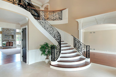 Foyer - large transitional medium tone wood floor foyer idea in Detroit with beige walls