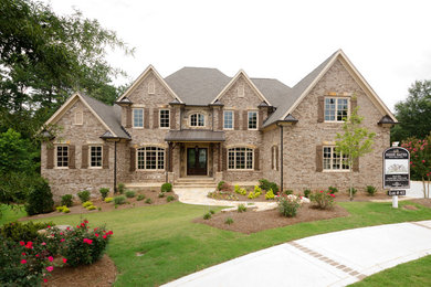 Inspiration for an expansive transitional three-storey brick brown exterior in Atlanta with a gable roof.