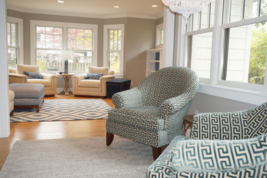 Living room - mid-sized enclosed light wood floor living room idea in Indianapolis with beige walls, a standard fireplace, a tile fireplace and a wall-mounted tv